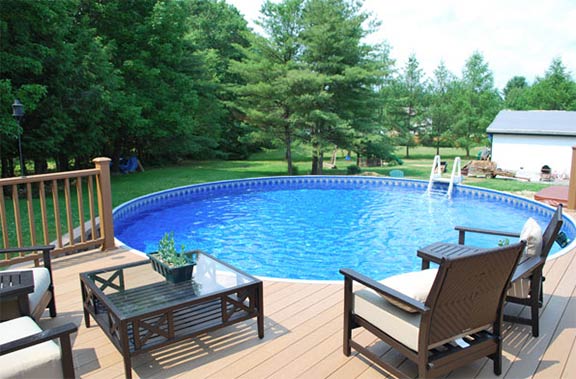 A Above Ground Pool with chairs and a table next to it.